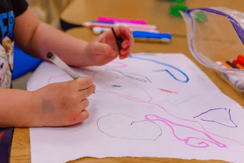 Child Drawing on paper in daycare