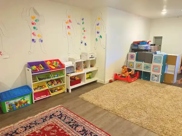 Indoor playroom with learning stations at Angel Home Family Child Care in Lynnwood, WA